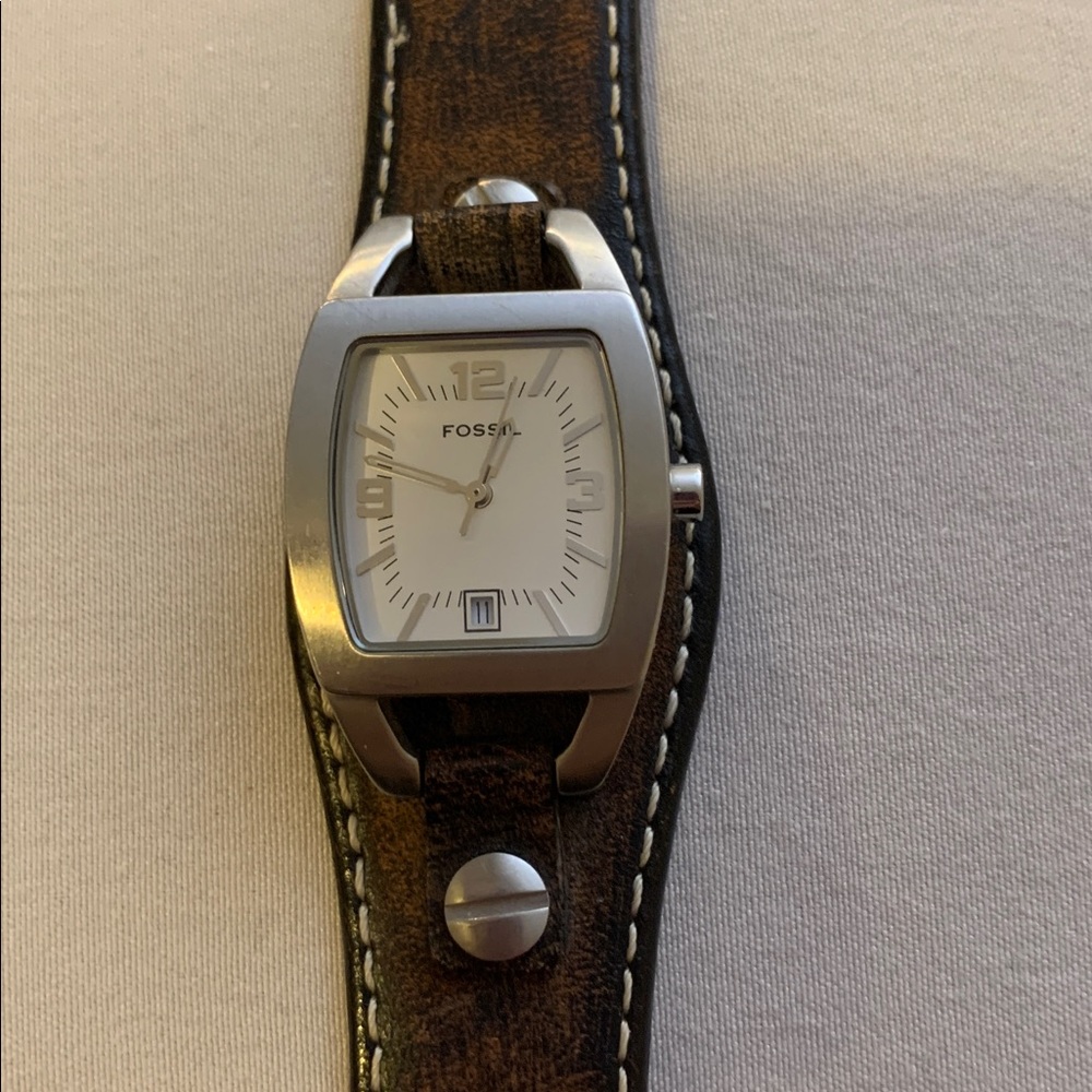 Fossil Wristwatch with Silver face and Dial and genuine brown leather strap.